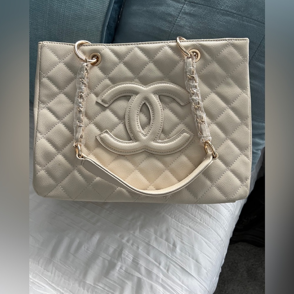 this Chanel purse is a medium sized hand bag cream colored and never ben used
